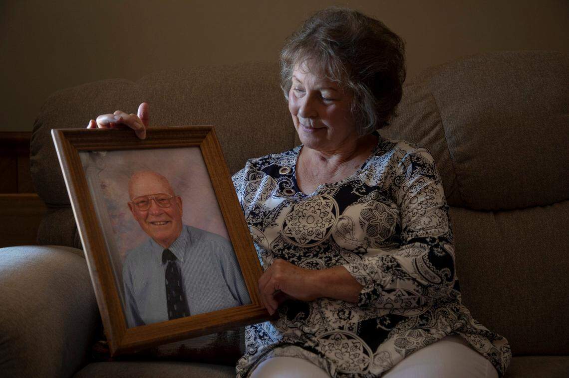 Deborah Williams sits for a portrait with a photograph of her father Roland Pittman who died three weeks after his evacuation on a boat from a Lumberton, N.C., nursing home by first responders and the Cajun Navy during Hurricane Florence and was then transferred to a home where Williams says he did not receive adequate care, on Friday, Oct. 11, 2019, in Lumberton, N.C.