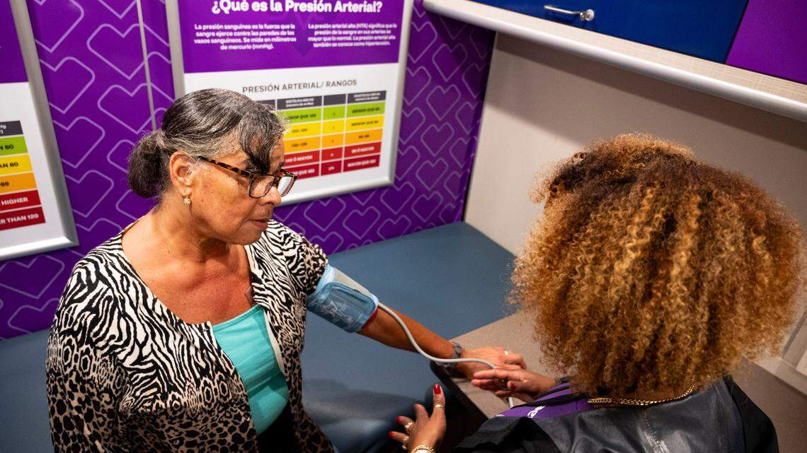 Lisa Hanif-Baldwin has her blood pressure monitored by Yohanny Monction inside the Aetna bus in Raleigh on Thursday, July 25, 2024.