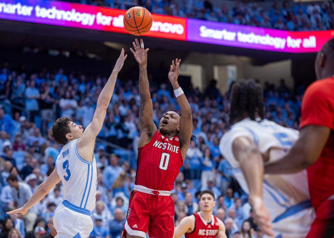 N.C. State’s D.J. Horne (0) puts up a shot against North Carolina’s Cormac Ryan (3) during the first half against N.C. State on Saturday, March 2, 2023 at the Smith Center in Chapel Hill, N.C.