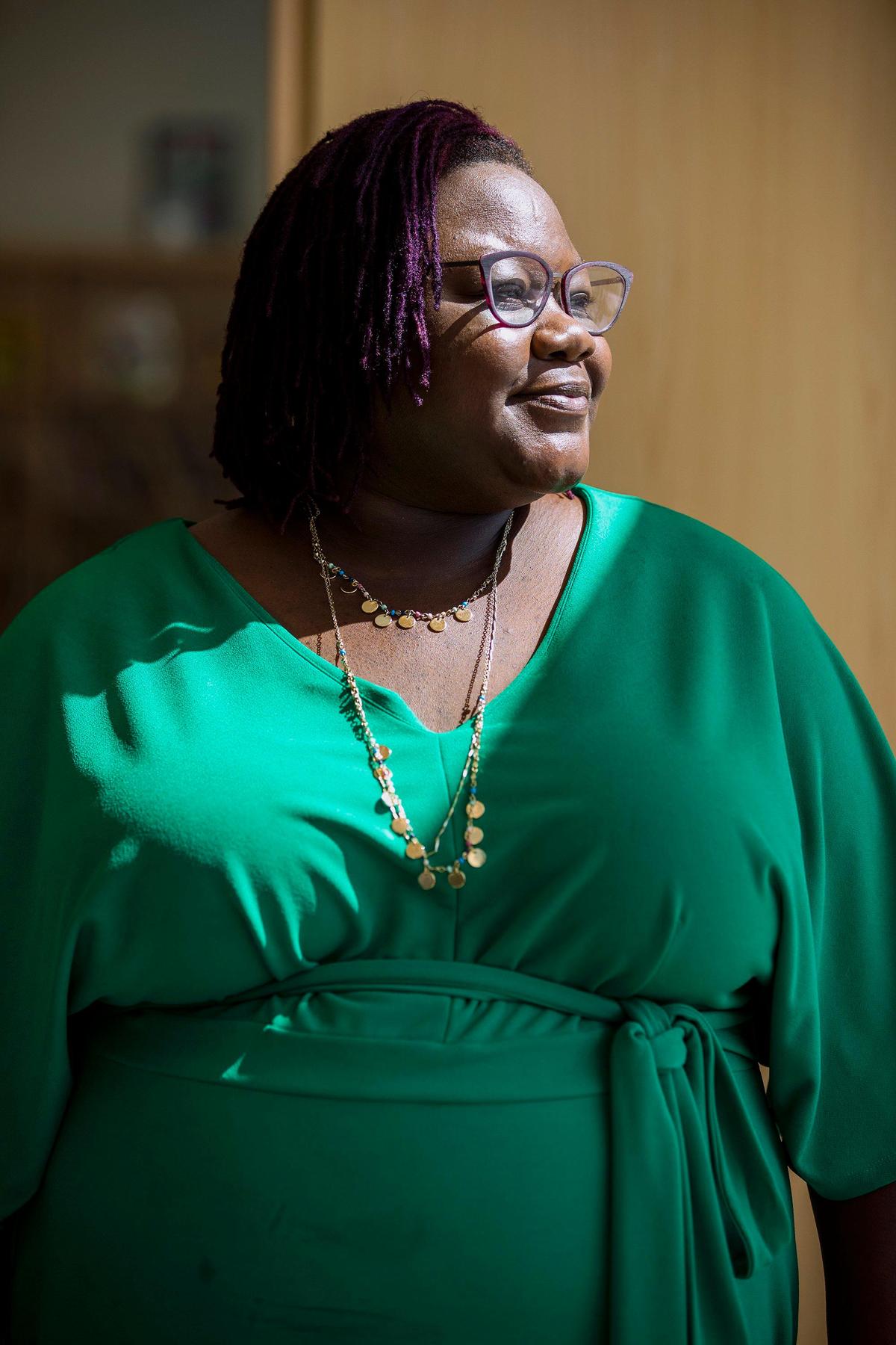 Kia Baker, executive director of Southeast Raleigh Promise, a non-profit coordinating efforts to revitalize communities in Southeast Raleigh, stands for a portrait in her favorite room of the newly constructed Southeast Raleigh Elementary School, built in collaboration with a YMCA facility at the Beacon Site which will soon also feature affordable housing units, on Tuesday, Sep. 24, 2019, in Raleigh, NC.