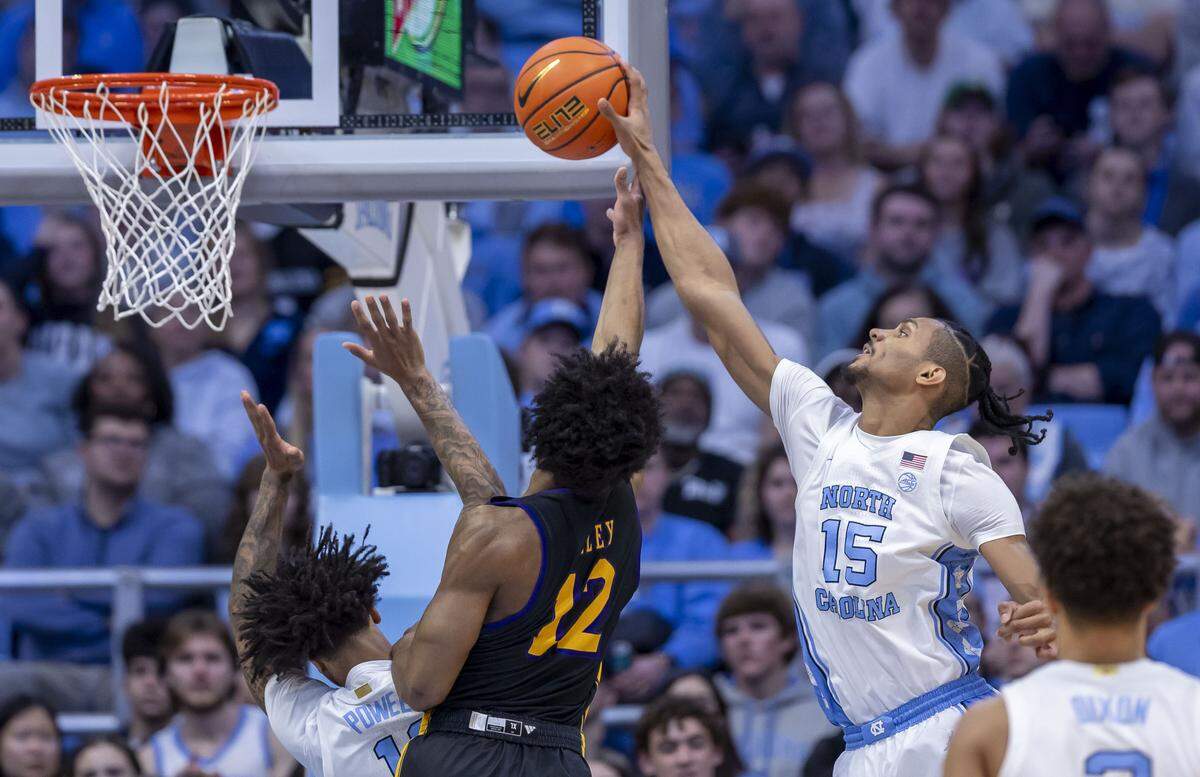 North Carolina forward Jarin Stevenson (15) blocks a shot by East Carolina guard Jordan Riley (12) in the first half on Monday, December 22, 2025 at the Smith Center in Chapel Hill, N.C. 