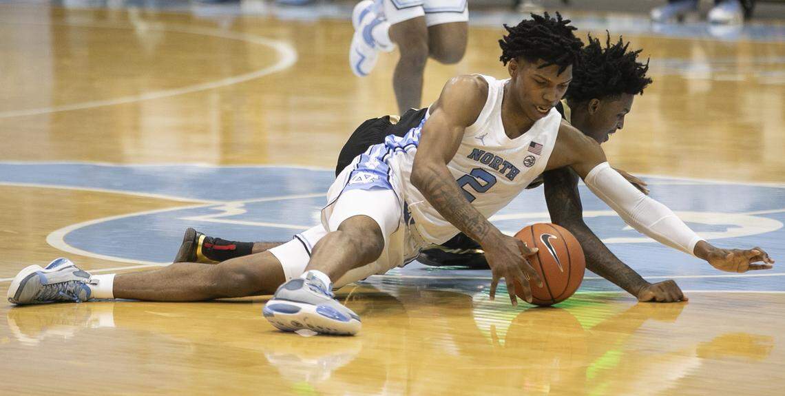 North Carolina’s Caleb Love (2) secures a loose ball from College of Charleston’s Zep Jasper (12) defense during the first half on Wednesday, November 25, 2020 at the Smith Center in Chapel Hill, N.C.