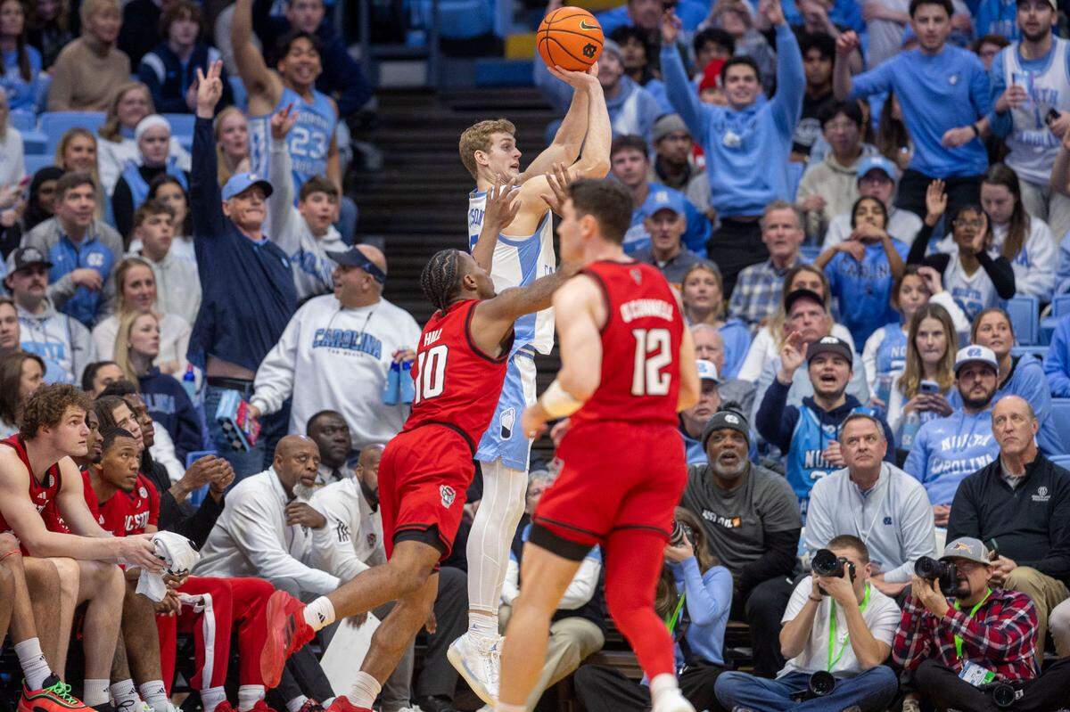 North Carolina forward Cade Tyson (5) launches a three point shot over N.C. State’s Marcus Hill Jr. (10) in the first half on Wednesday, February 19, 2025 in Chapel Hill, N.C.