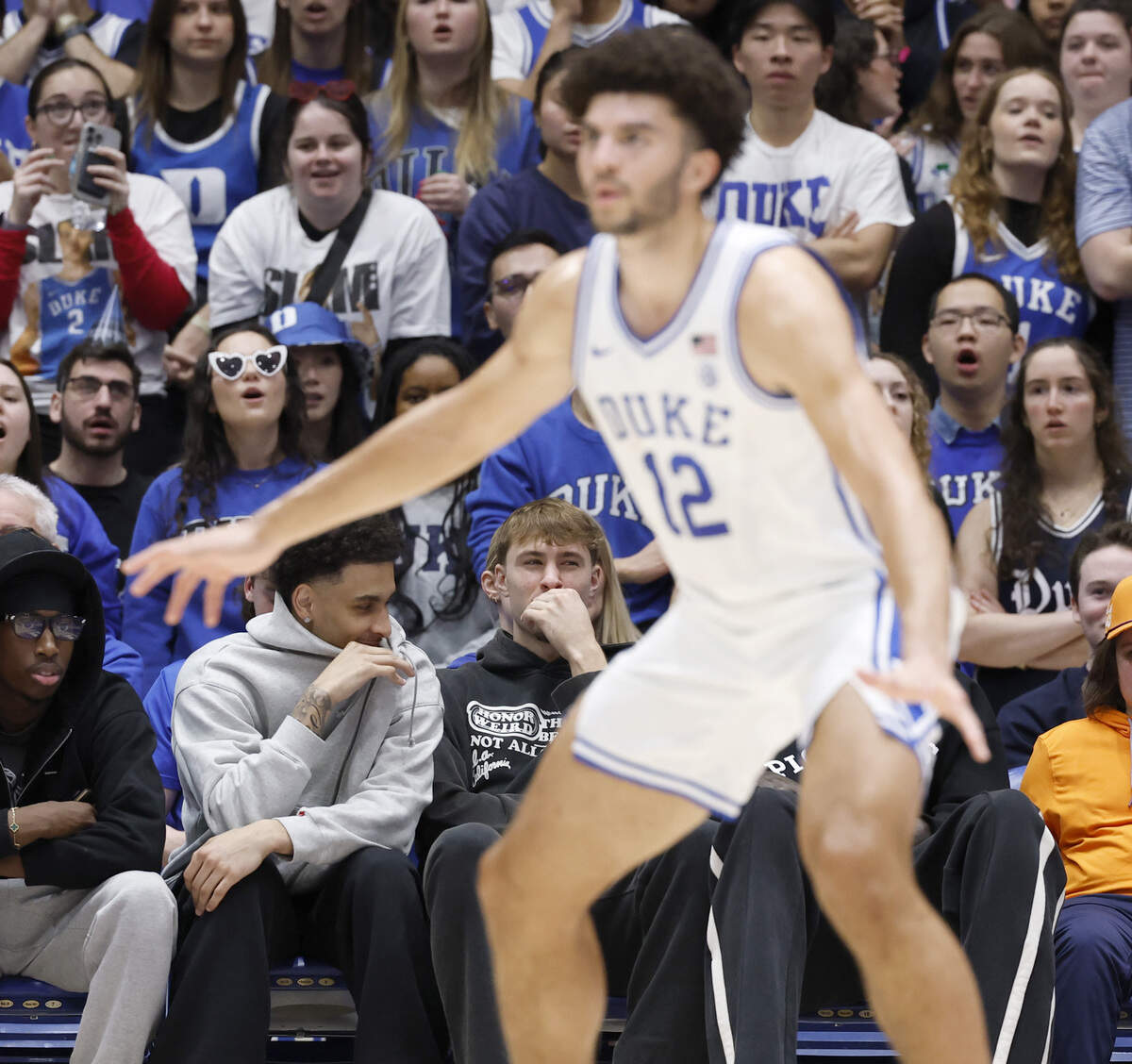 Former Duke players Tyrese Proctor and Cooper Flagg watch Cameron Boozer (12) and the team play during the first half of Duke’s game against Clemson at Cameron Indoor Stadium in Durham, N.C., Sat., Feb. 14, 2026.
