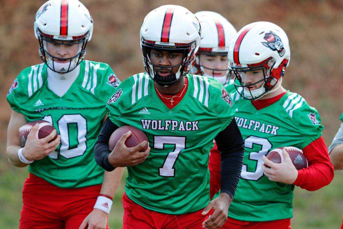 N.C. State quarterback Matthew McKay (7) runs drills with fellow quarterbacks including Micah Leon (10) and Devin Leary (13) during the Wolfpack’s first day of spring practice Saturday, March 2, 2019.