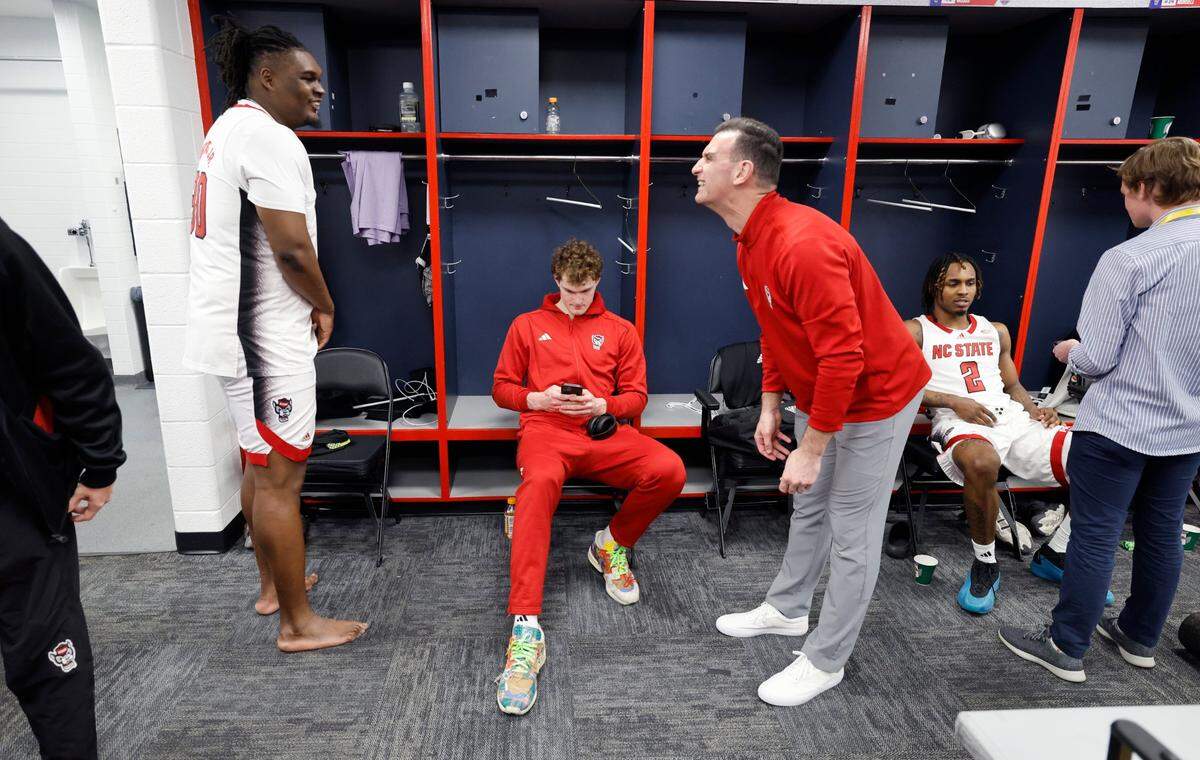 N.C. State’s DJ Burns Jr. (30) laughs with strength and conditioning coach Pat Murphy in the locker room after the Wolfpack’s 94-85 victory over Louisville in the first round of the 2024 ACC Men’s Basketball Tournament at Capital One Arena in Washington, D.C., Tuesday, March 12, 2024.