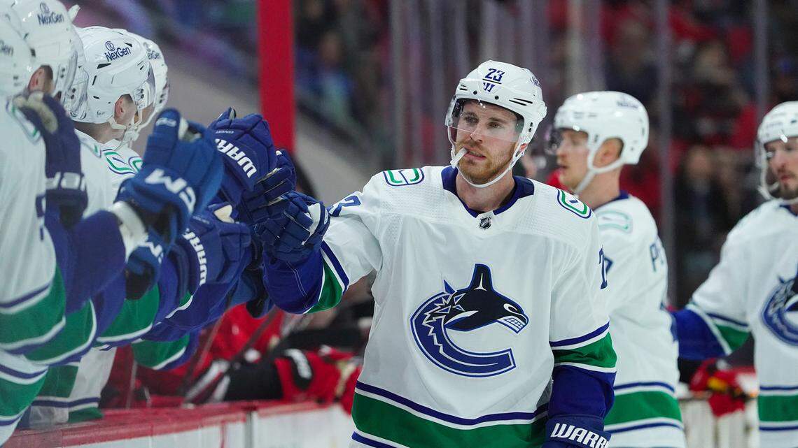 Feb 6, 2024; Raleigh, North Carolina, USA; Vancouver Canucks center Elias Lindholm (23) celebrates his goal against the Carolina Hurricanes during the first period at PNC Arena. Mandatory Credit: James Guillory-USA TODAY Sports
