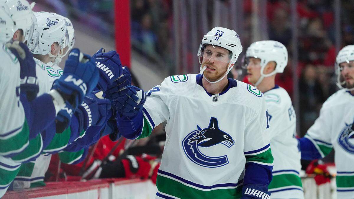 Feb 6, 2024; Raleigh, North Carolina, USA; Vancouver Canucks center Elias Lindholm (23) celebrates his goal against the Carolina Hurricanes during the first period at PNC Arena. Mandatory Credit: James Guillory-USA TODAY Sports