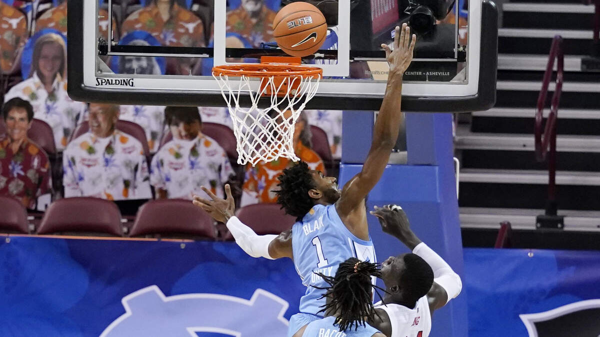 North Carolina guard Leaky Black (1) tries to block a shot by UNLV forward Cheikh Mbacke Diong (34) in the first half of an NCAA college basketball game in the Maui Invitational tournament, Monday, Nov. 30, 2020, in Asheville, N.C.