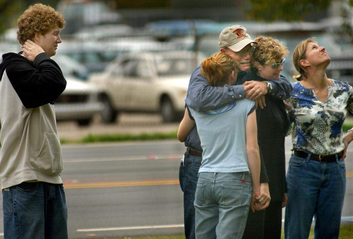 Steve Cox, left, and his mother Diane Cox, right, join the family of Nolan Myers, sister Jourdan, 14, left, and his parents Philip and Terrie, at the site of an accident Saturday night that killed Nolan and five others who had stopped to help victims of another car accident. Nolan, a student at Campbell University, grew up in Minnesota where his family still lives. There were 18 balloons, one for each year of Nolan's life, that were sent off with messages of thanks from his family. Cox was a fellow student at Campbell and close friend of Nolan's.