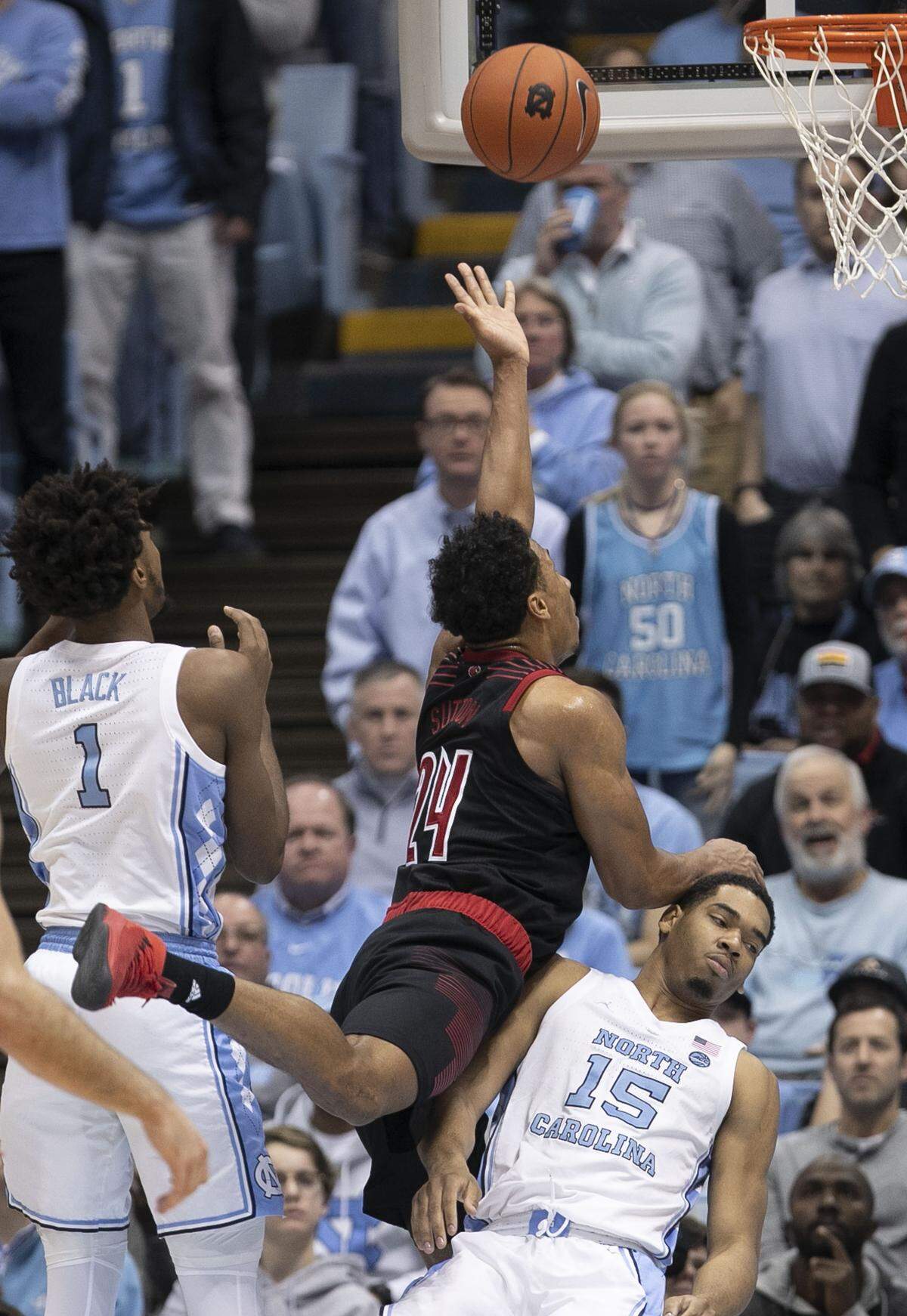 Louisville’s Dwayne Sutton (24) collides with North Carolina’s Garrison Brooks (15) during the second half on Saturday, January 12, 2019 at the Smith Center in Chapel Hill, N.C.