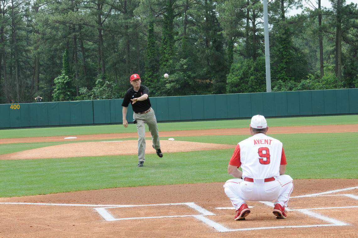 Longtime NC State sports information director for baseball Bruce Winkworth throws out a ceremonial first pitch before a Wolfpack game in 2012. Winkworth, 67, passed away on Friday afternoon.