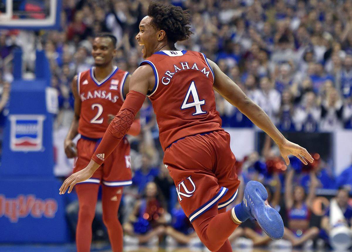 For senior night, KU's Devonte' Graham requested the Jayhawks don their red uniforms for their game against Texas. KU got off to a flying start and Graham was all smiles after dishing an assist to fellow senior Svi Mykhailiuk during the first half. KU led 45-32 at the break.