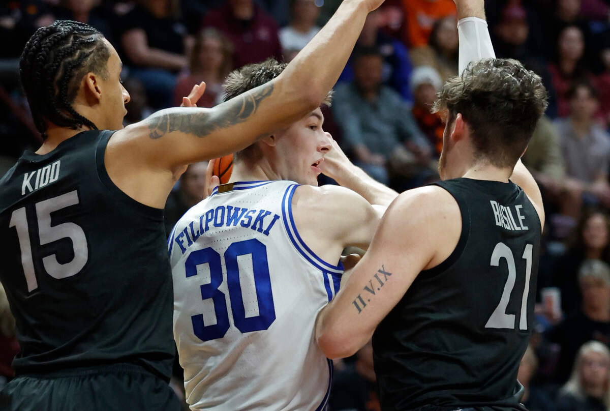 Virginia Tech’s Lynn Kidd (15) and Grant Basile (21) defend Duke’s Kyle Filipowski (30) during the second half of Virginia Tech’s 78-75 victory over Duke at Cassell Coliseum in Blacksburg, VA., Monday, Jan. 23, 2023.