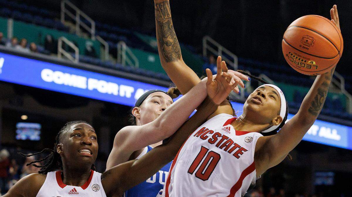 N.C. State’s Saniya Rivers and Aziaha James battle Duke’s Kennedy Brown for a rebound during the first half of an ACC Tournament quarterfinal game on Friday, March 8, 2024, at Greensboro Coliseum in Greensboro, N.C.