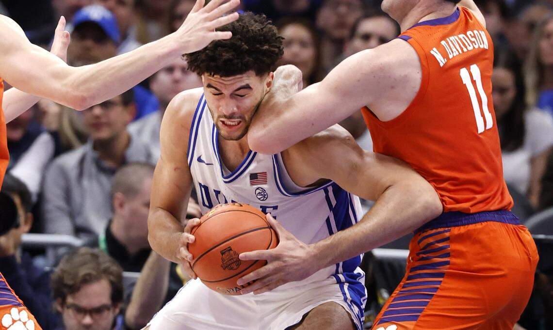 Duke’s Cameron Boozer (12) is defended by Clemson's Nick Davidson (11) during the first half of Duke’s game against Clemson in the semifinals of the 2026 ACC Men’s Basketball Tournament at the Spectrum Center in Charlotte, N.C., Friday, March 13, 2026.