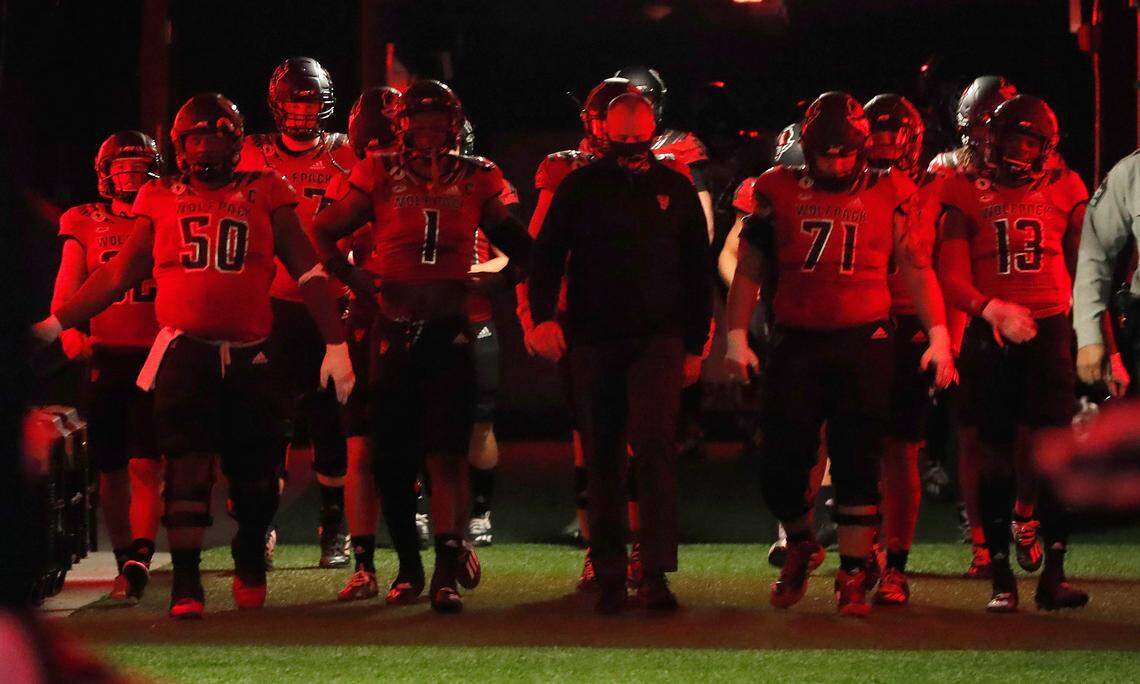 N.C. State head coach Dave Doeren and the team head towards the field before N.C. State’s game against Florida State at Carter-Finley Stadium in Raleigh, N.C., Saturday, Nov. 14, 2020.