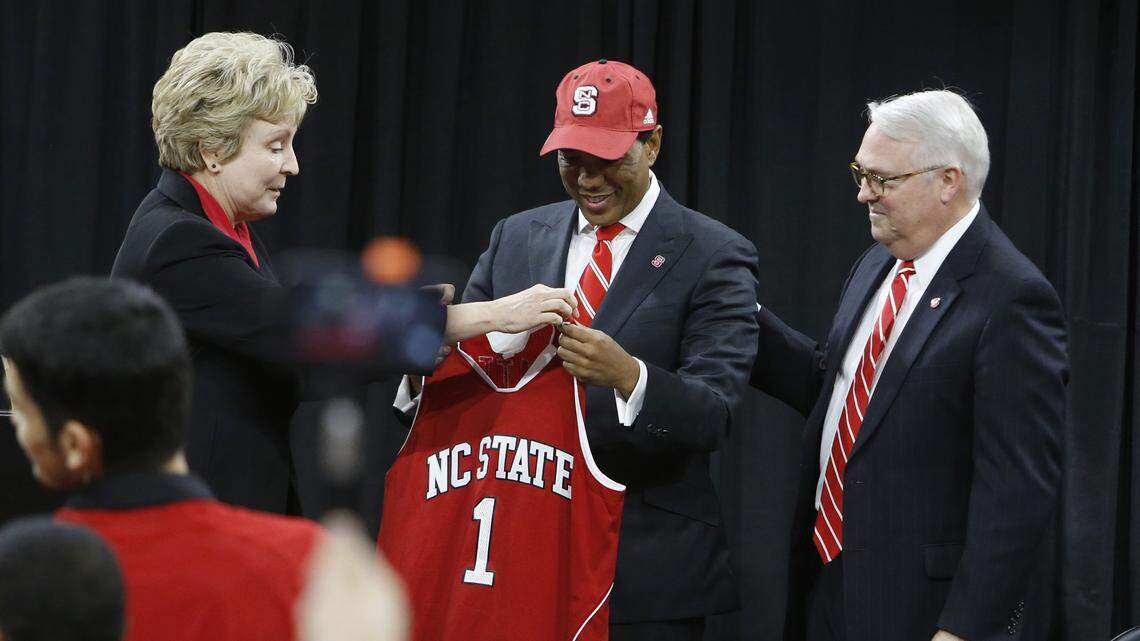 New N.C. State head men’s basketball coach Kevin Keatts, center, gets a hat and jersey from athletic director Debbie Yow, left, and Chancellor Randy Woodson during an introductory press conference at Reynolds Coliseum in Raleigh, N.C., Sunday, March 19, 2017.
