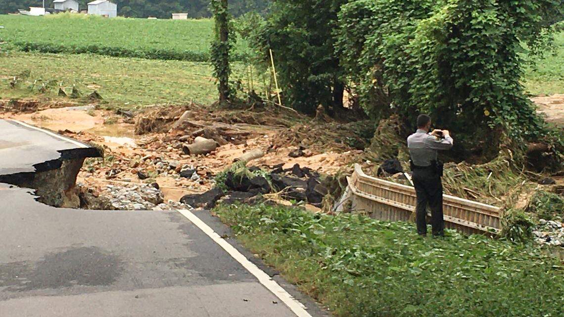 The washed out portion of Galilee Road near Smithfield, N.C. where fast-moving water pushed a car with a mother and her children into a nearby creek Monday night, Aug. 30, 2020. The mother was rescued, but authorities were still searching for the two children Tuesday morning.