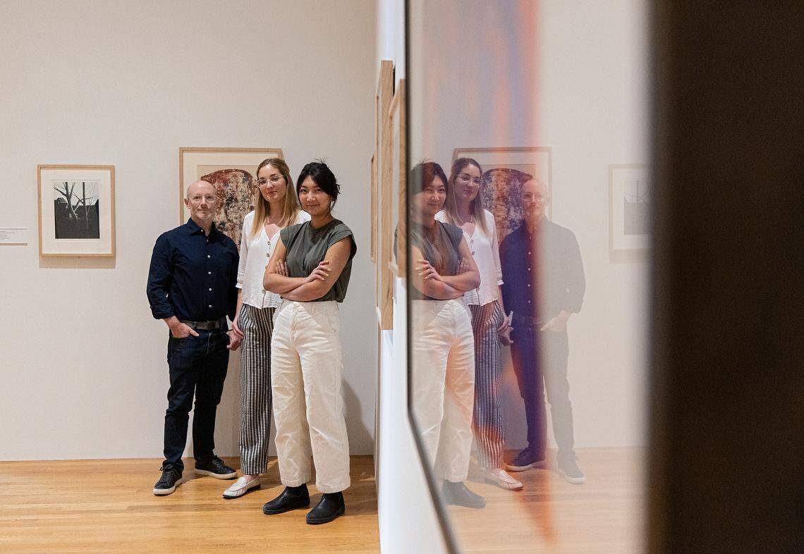 Marshall Price, chief curator, Julia McHugh, curator and director of academic initiatives, and Julianne Miao, curatorial assistant, are pictured in an exhibit curated by A.I. at the Nasher Museum of Art at Duke University on Thursday, Sept. 14, 2023, in Durham, N.C. The A.I. model, designed by a Duke professor, selected artworks for the exhibition and gave it a title — “Dreams of Tomorrow: Utopian and Dystopian Visions.”