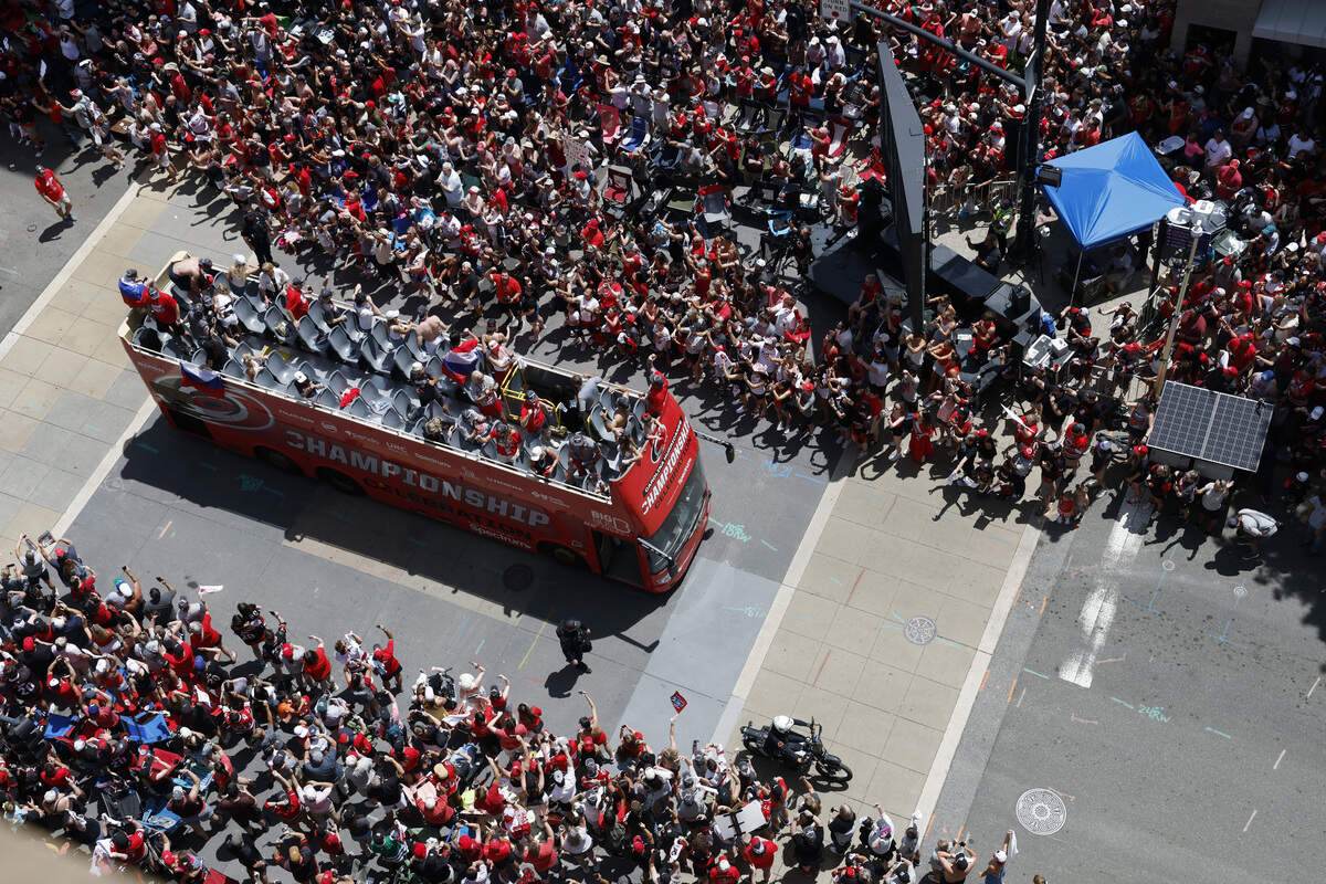 Buses carrying Carolina Hurricanes players and families along the parade route celebrating their Stanley Cup Championship.
