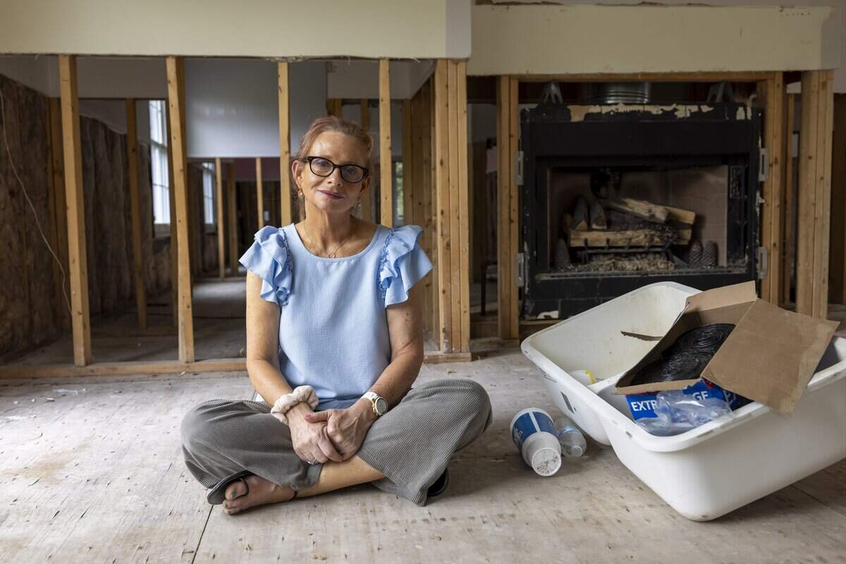 Jennifer Johnson in the gutted living room of her home in the Weatherhill Pointe neighborhood of Carrboro on Tuesday, Aug. 19, 2025.