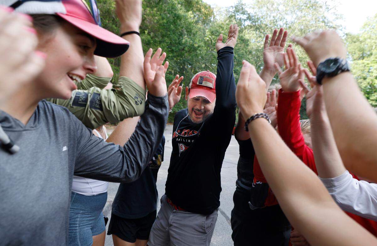 Head coach Dana Magliola leads the N.C. State sailing team in a cheer after practice at Lake Crabtree in Morrisville, N.C., Friday, Sept. 6, 2024.
