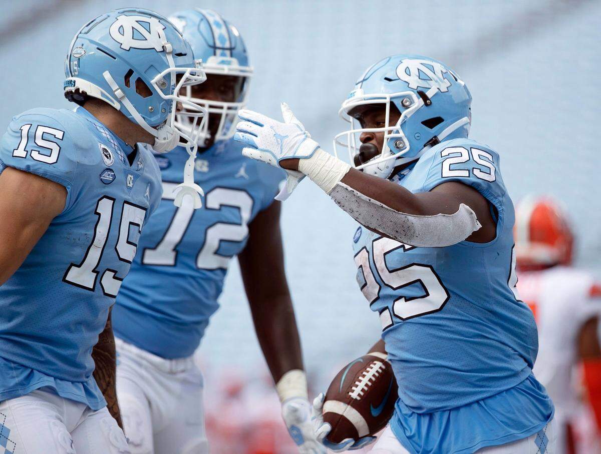 North Carolina’s Javonte Williams (25) celebrates with teammates after scoring a touchdown to give the Tar Heels’ a 24-6 lead in the fourth quarter against Syracuse on Saturday, September 12, 2020 in Chapel Hill, N.C