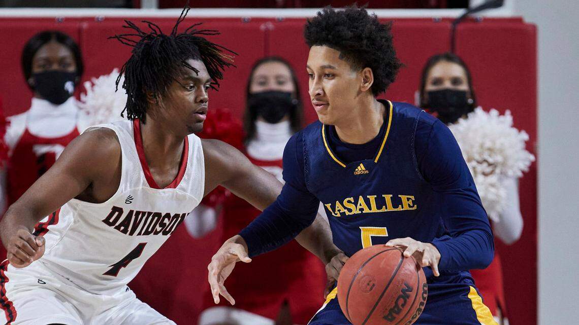 La Salle guard Jack Clark (5) is guarded by Davidson guard Desmond Watson (4) during the first half of an NCAA college basketball game on Sunday, Jan. 30, 2022, in Davidson, N.C.