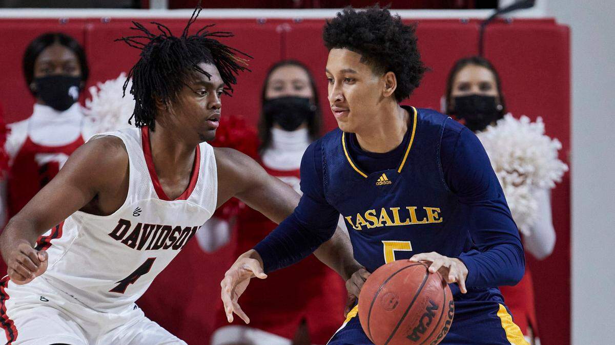 La Salle guard Jack Clark (5) is guarded by Davidson guard Desmond Watson (4) during the first half of an NCAA college basketball game on Sunday, Jan. 30, 2022, in Davidson, N.C.