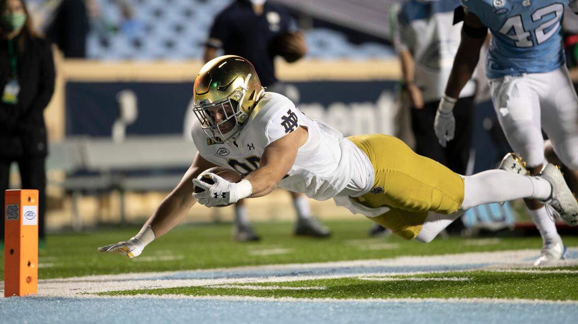 Notre Dame’s George Takacs (85) gets past North Carolina’s Tyrone Hopper (42) picking up 13 yards on a pass completion from quarterback Ian Book (12) and dives toward the goal line to set up Notre Dame’s final score late in the fourth quarter, and secure their 31-17 victory over North Carolina.