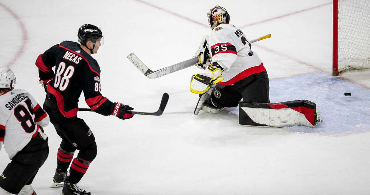 Carolina’s Hurricanes’ Martin Necas (88) scores the game winning goal on Ottawa goalie Leevi Merilainen (35) in overtime to secure a 3-2 victory on Tuesday, April 4, 2023 at PNC Arena in Raleigh, N.C.