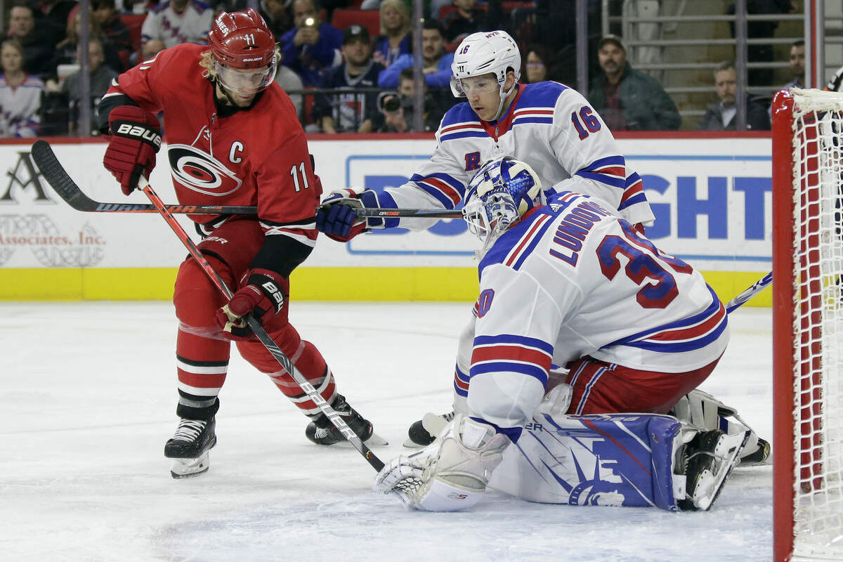 New York Rangers goaltender Henrik Lundqvist (30), of Sweden, blocks Carolina Hurricanes center Jordan Staal (11) while Rangers center Ryan Strome (16) helps defend during the second period of an NHL hockey game in Raleigh, N.C., Thursday, Nov. 7, 2019. (AP Photo/Gerry Broome)