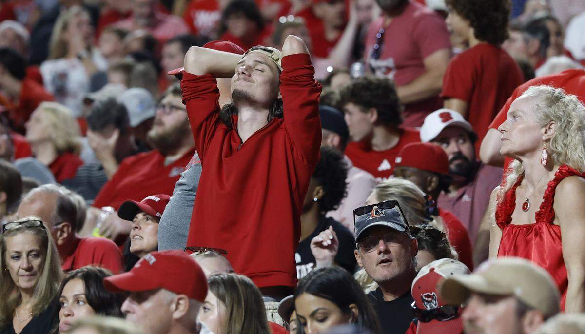 A Wolfpack fan reacts after Virginia Tech made a first down during the first half of N.C. State’s game against Virginia Tech at Carter-Finley Stadium in Raleigh, N.C., Saturday, Sept. 27, 2025.