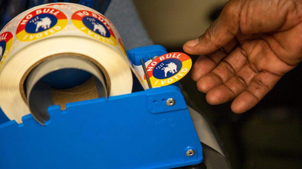 Kenneth Keith takes a sticker after casting his ballot on Election Day, Nov. 3, 2020, in Durham. In a solidly blue congressional district that includes Durham and Chapel Hill, whoever wins North Carolina’s 4th District primary will have an easy path to winning the general election.