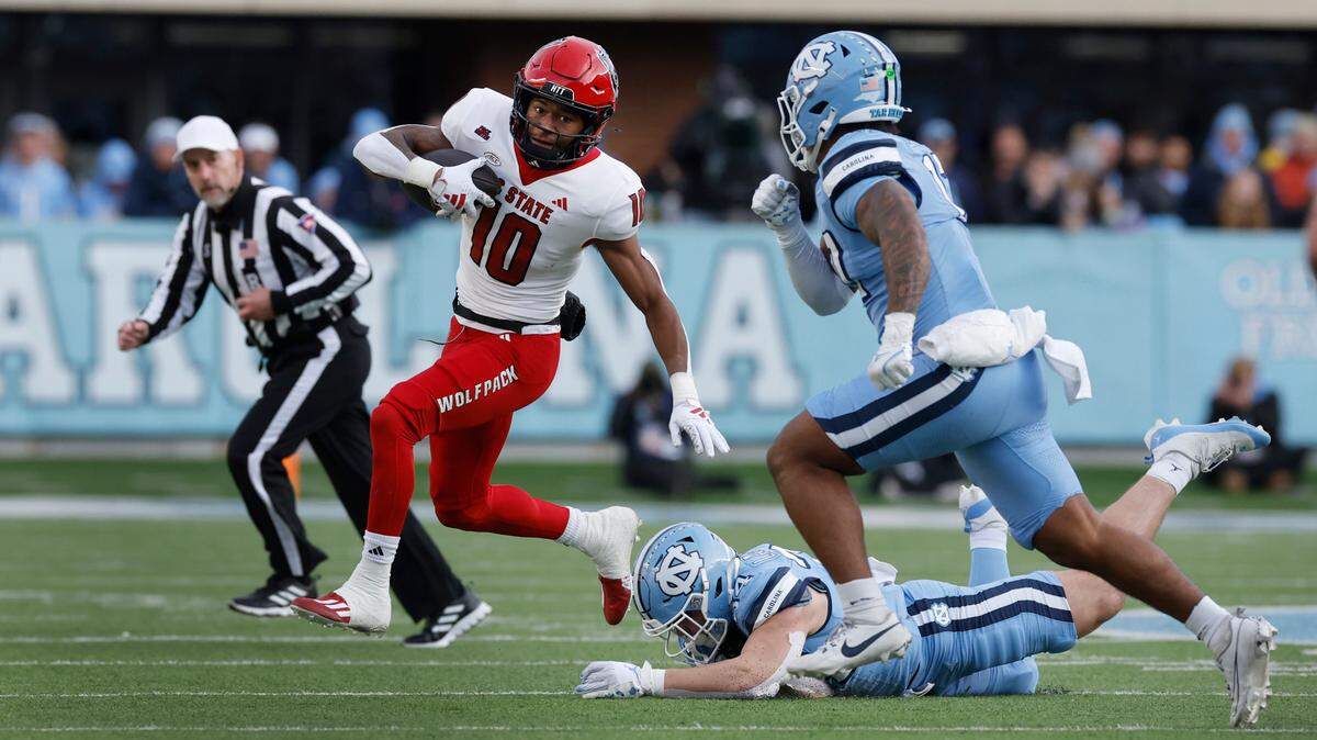N.C. State wide receiver KC Concepcion (10) breaks away from North Carolina linebacker Caleb LaVallee (34) during the first half of N.C. State’s game against UNC at Kenan Stadium in Chapel Hill, N.C., Saturday, Nov. 30, 2024.