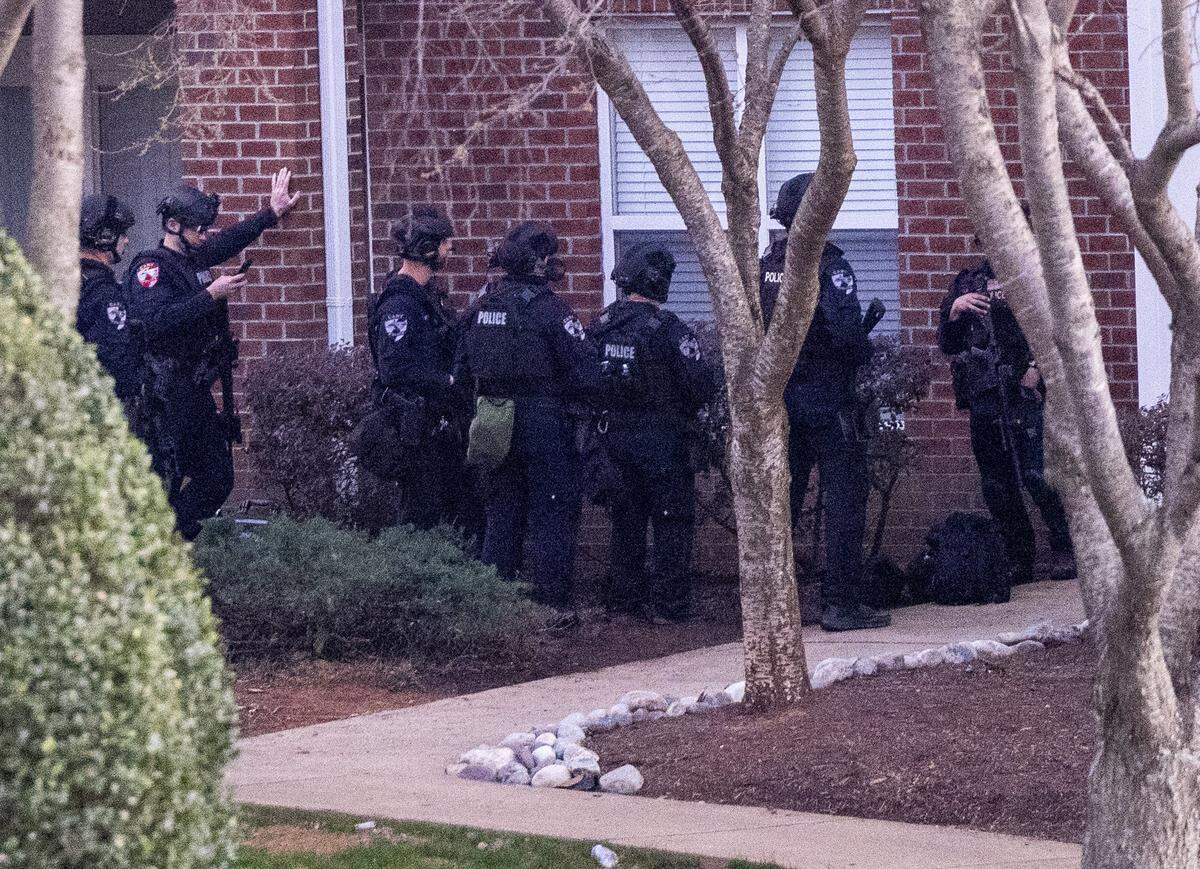 Law enforcement officers work the scene of a standoff at Tryon Villages apartments in Cary Wednesday, Feb. 22, 2023.