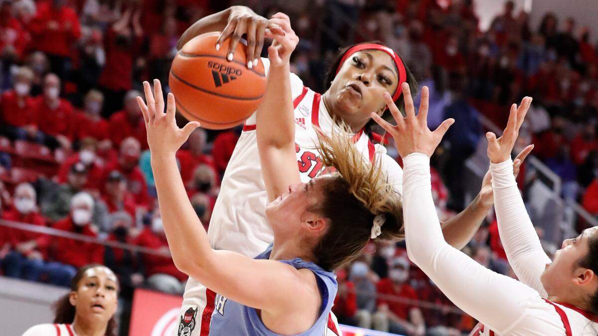 N.C. State’s Jada Boyd (5) blocks the shot by North Carolina’s Eva Hodgson (10) during the first half of N.C. State’s game against UNC at Reynolds Coliseum in Raleigh, N.C., Thursday, January 6, 2022.