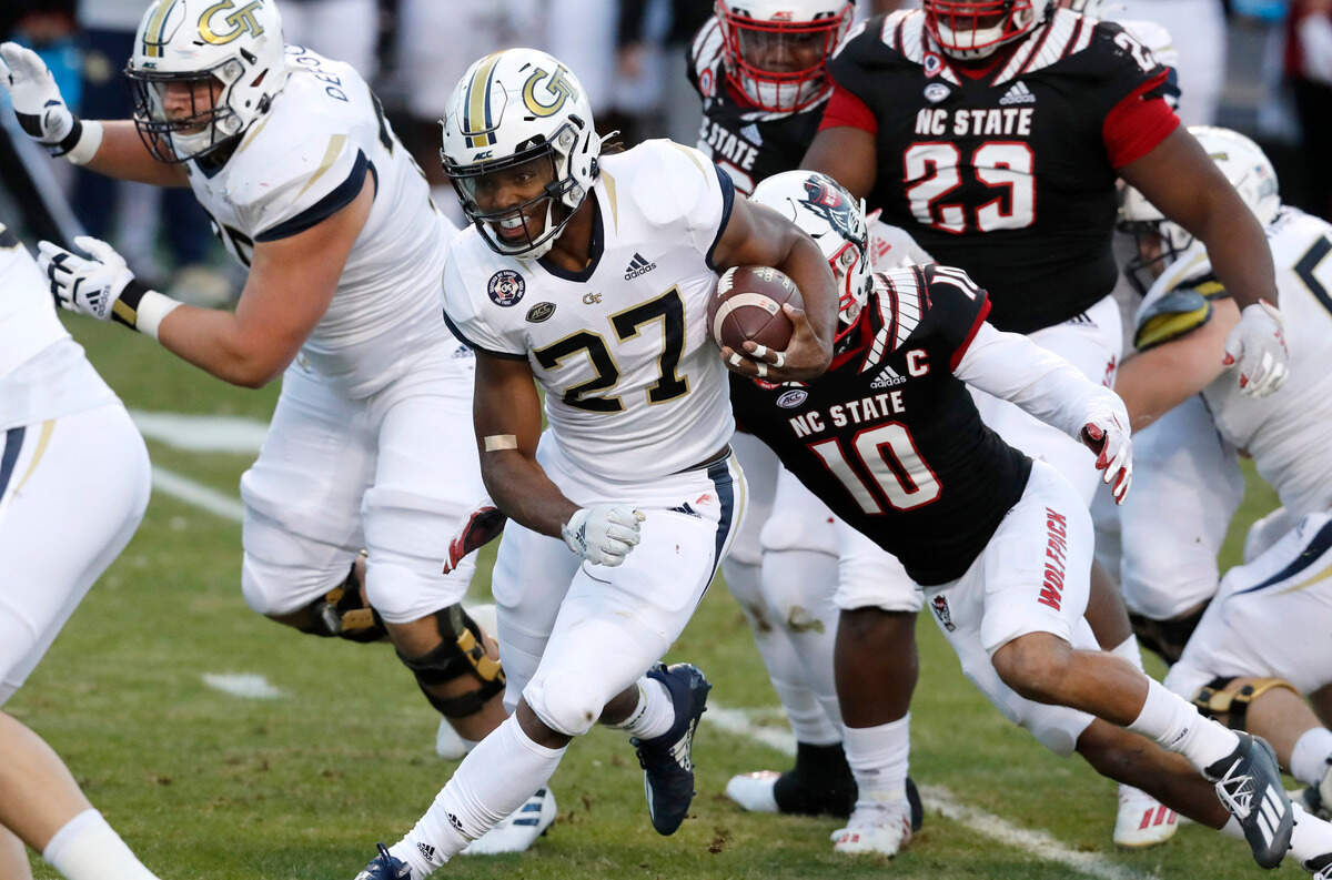 Georgia Tech running back Jordan Mason (27) runs through the N.C. State defense during the first half of N.C. State’s game against Georgia Tech at Carter-Finley Stadium in Raleigh, N.C., Saturday, Dec. 5, 2020.