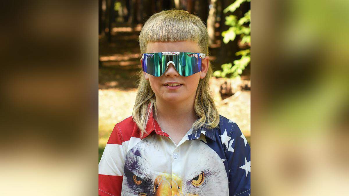 Emmett Miller stands to win the USA Mullet Championship for his majestic do. “Because I like it that way,” said the 7-year-old from Moore County.