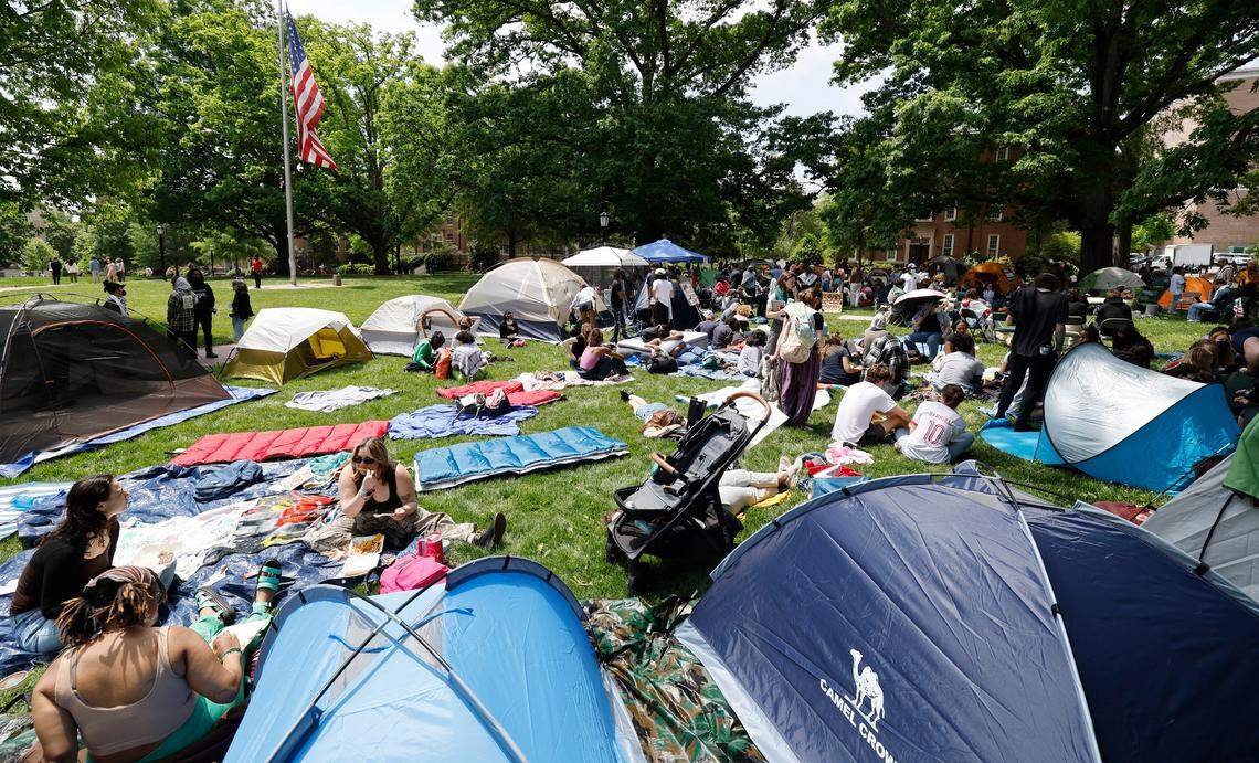 Protesters gather amongst their tents as part of a Gaza Solidarity Encampment at Polk Place on the campus of UNC-Chapel Hill on Friday afternoon, April 26, 2024.