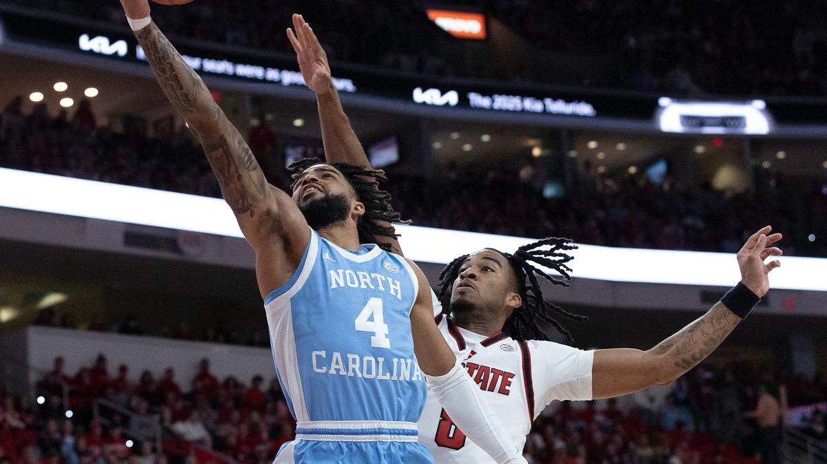 North Carolina’s RJ Davis drives to the basket past N.C. State’s Jayden Taylor during the first half of the Tar Heels’ 63-61 win on Saturday, Jan. 11, 2025, at Lenovo Center in Raleigh, N.C.