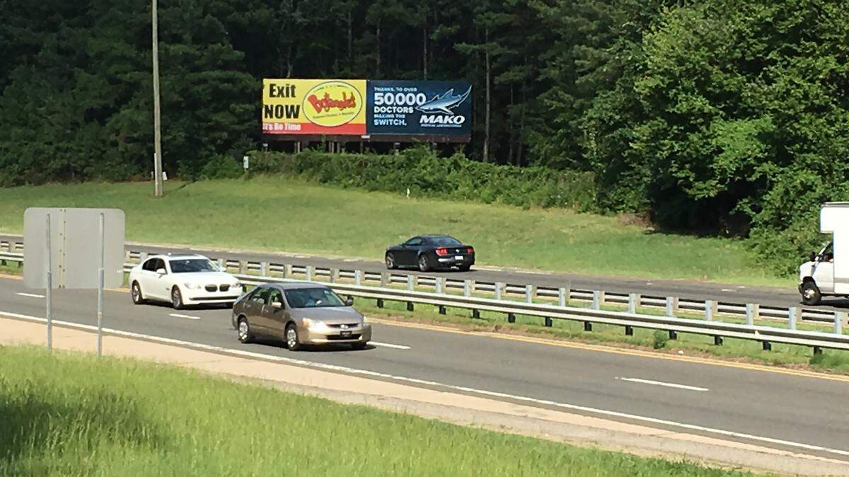 A law approved by state lawmakers over Gov. Roy Cooper's veto increases the number of trees the billboard industry can cut on state highway right-of-way