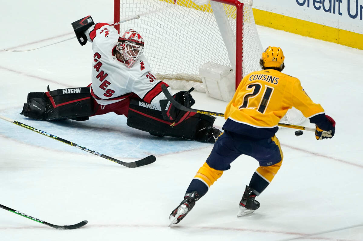 Carolina Hurricanes goaltender Alex Nedeljkovic (39) blocks a shot by Nashville Predators center Nick Cousins (21) during the third period in Game 4 of an NHL hockey Stanley Cup first-round playoff series Sunday, May 23, 2021, in Nashville, Tenn.