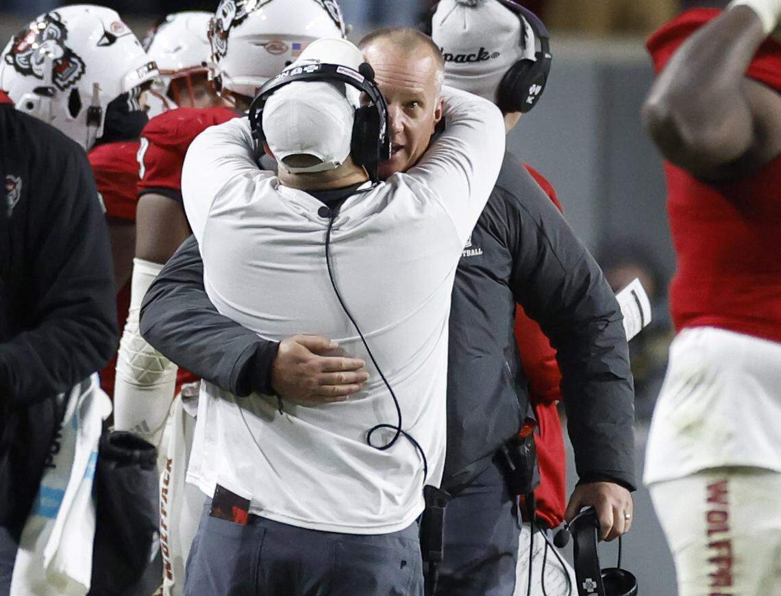 N.C. State head coach Dave Doeren hugs defensive coordinator Tony Gibson as time runs out during the Wolfpack’s 39-20 victory over UNC at Carter-Finley Stadium in Raleigh, N.C., Saturday, Nov. 25, 2023.