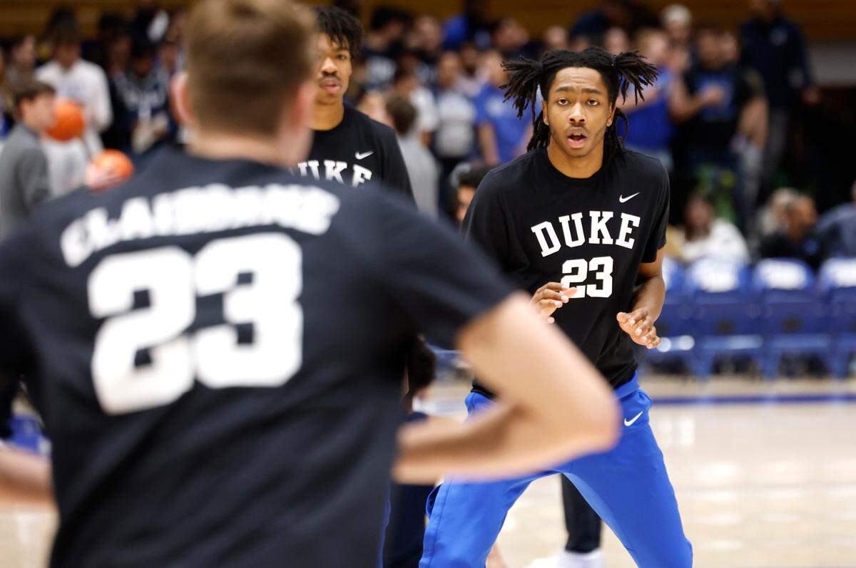 Duke players, including Cooper Flagg, left, and Isaiah Evans warm up while wearing C.B. Claiborne warm up shirts before the Blue Devils’ game against California at Cameron Indoor Stadium in Durham, N.C., Wednesday, Feb. 12, 2025.