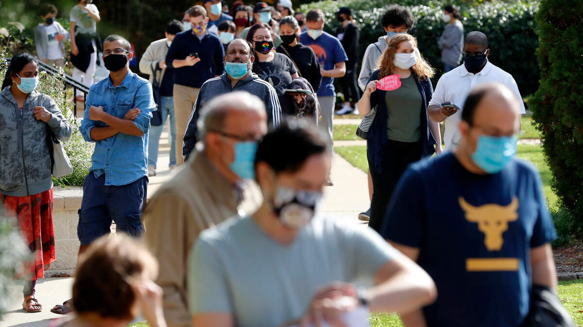Voters wait in line at the Cary Senior Center in Cary, N.C. during the final day of early voting Saturday, Oct. 31, 2020. The line at the senior center was a little over an hour long.