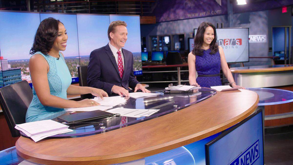 Jeff Hogan, center, with Lena Tillett and Renee Chou on the WRAL set. Hogan joined the station in January. In July, he was injured at Wrightsville Beach in what he describes as a “freak accident” while body surfing. He has returned to WRAL full-time.