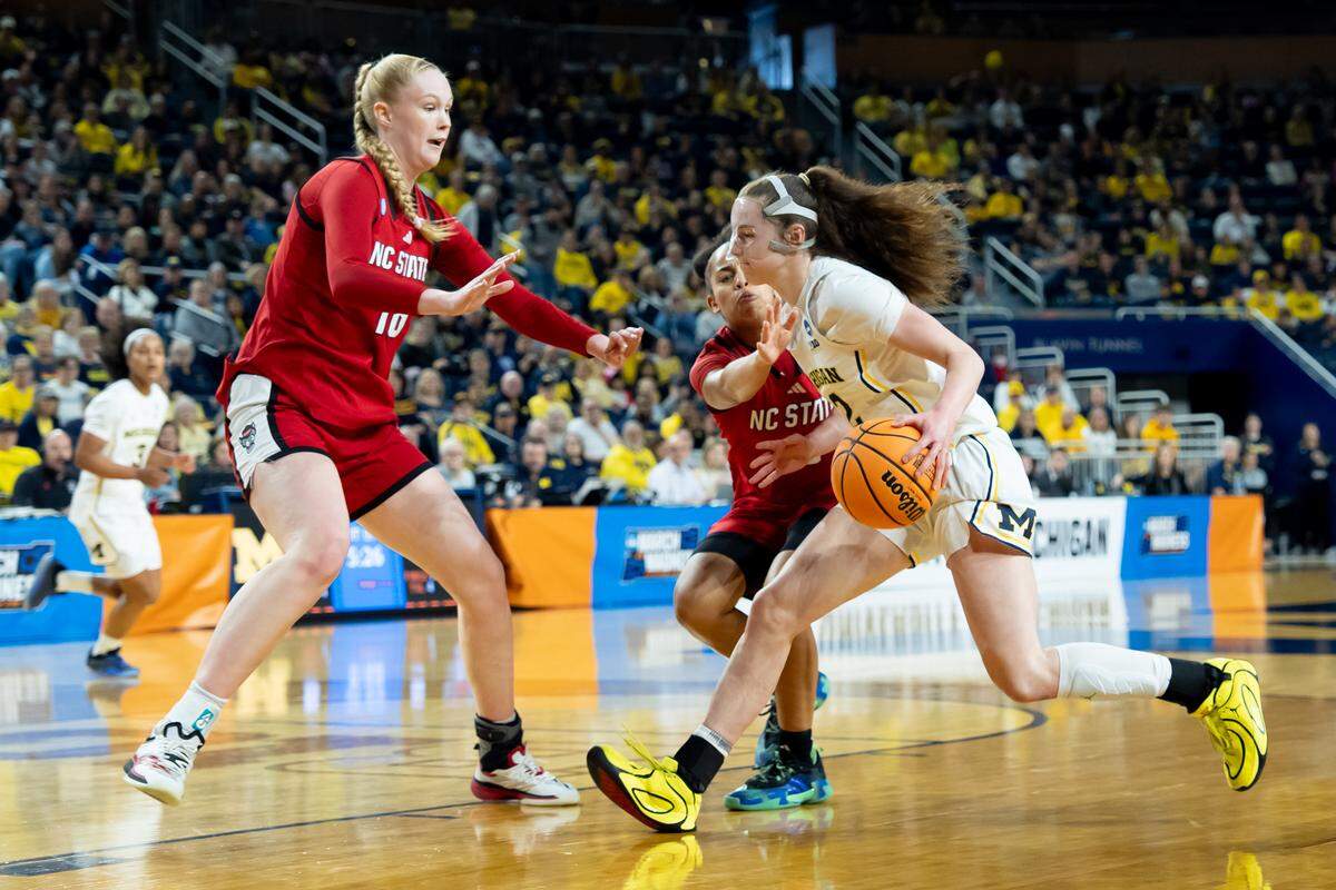 Michigan’s Syla Swords, right, drives to the basket against N.C. State’s Tilda Trygger, left, and Zamareya Jones during the teams’ NCAA Women’s Basketball Tournament Round of 32 game at Crisler Arena on March 22, 2026 in Ann Arbor, Michigan.