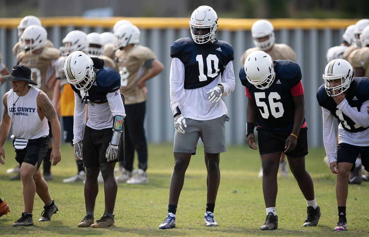 Lee County’s Desmond Evans (10) lines up to run sprints with his teammates during practice on Saturday, August 3, 2019 at Lee County High School in Sanford, N.C.